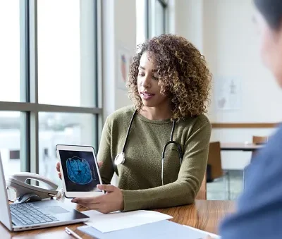 serious neurologist discusses mri scan with patient