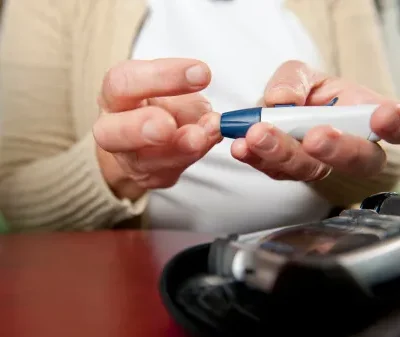 woman using diabetes test kit